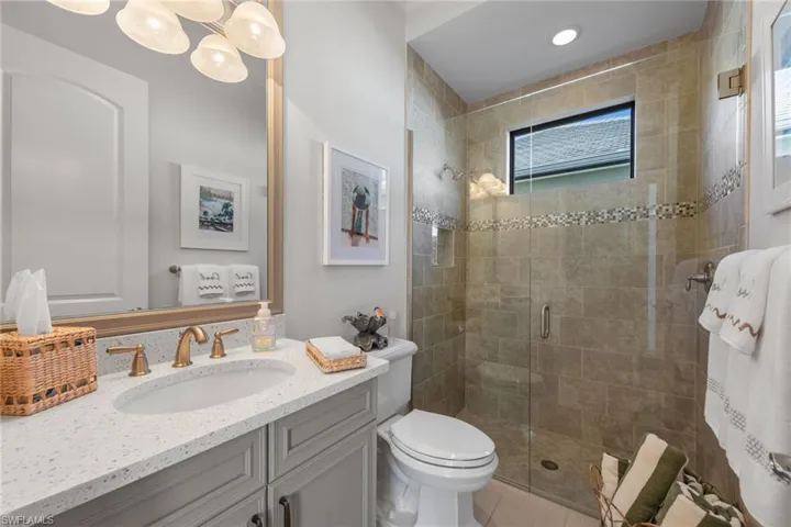 Full bathroom featuring vanity and a shower stall