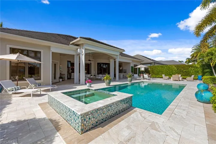 View of swimming pool with a patio area and a pool with connected hot tub