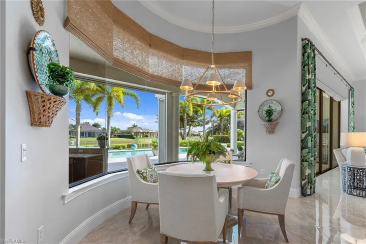 Dining area with a chandelier and crown molding