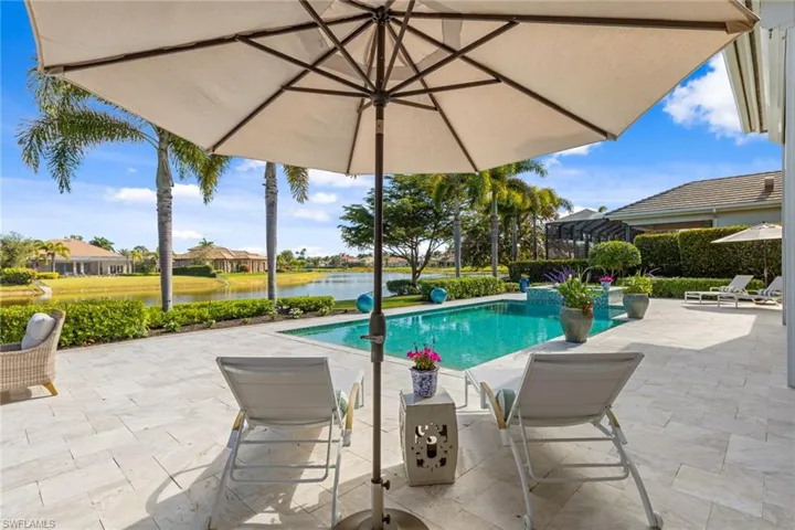 Swimming pool featuring a patio and a water view
