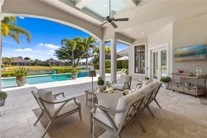 View of patio / terrace with an outdoor hangout area, french doors, a ceiling fan, a pool with connected hot tub, and a water view
