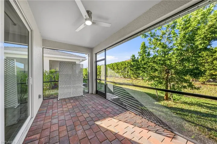 Unfurnished sunroom with ceiling fan