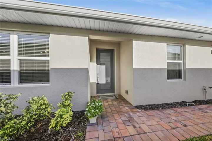Entrance to property featuring stucco siding