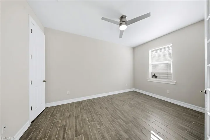 Spare room with wood tiled floors and ceiling fan