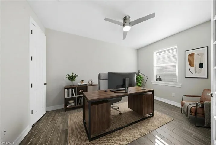 Office space featuring wood tiled floors and a ceiling fan