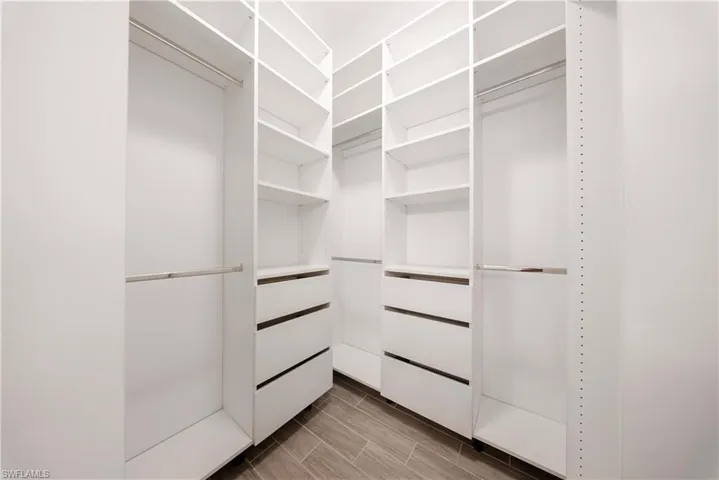 Walk in closet featuring wood finish floors