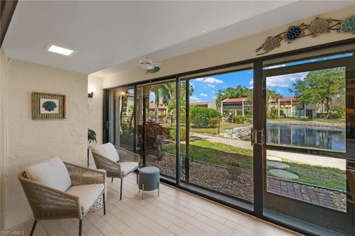 Sunroom featuring a water view