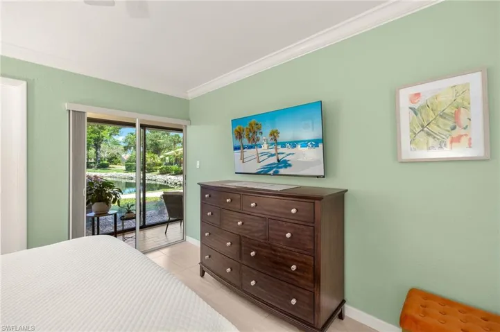 Bedroom with baseboards, access to exterior, light tile patterned flooring, and ornamental molding