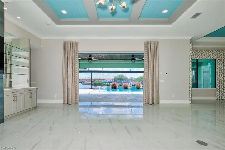 Spare room featuring a ceiling fan, light marble finish flooring, ornamental molding, and recessed lighting