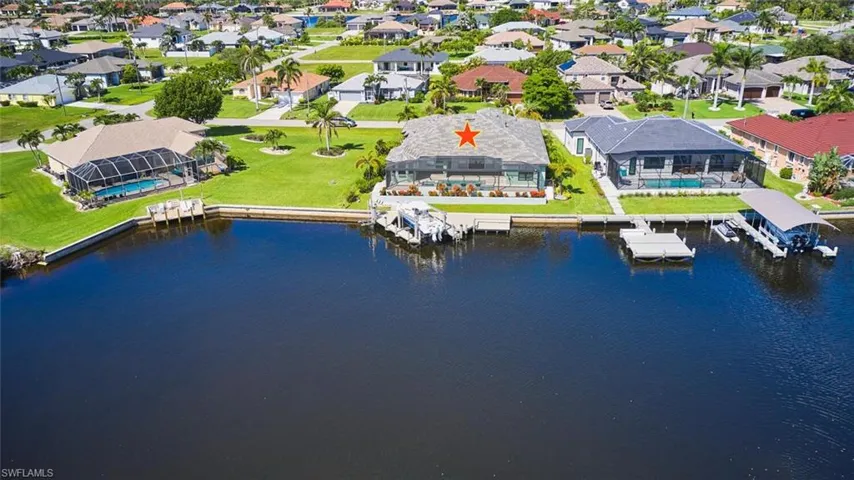 Aerial perspective of suburban area with a large body of water