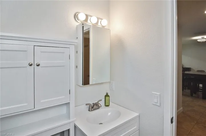 Bathroom with tile patterned flooring and vanity
