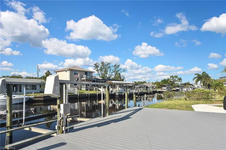 Dock area with a water view, a residential view, and boat lift