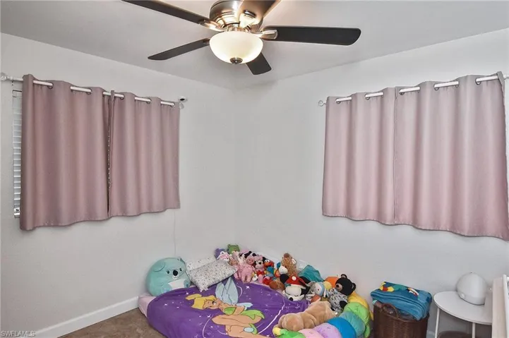Unfurnished bedroom featuring ceiling fan and baseboards