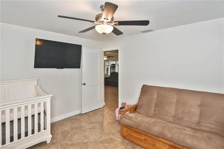 Bedroom with visible vents, baseboards, and ceiling fan