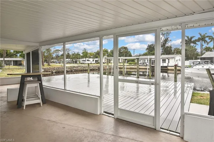 Unfurnished sunroom featuring a water view