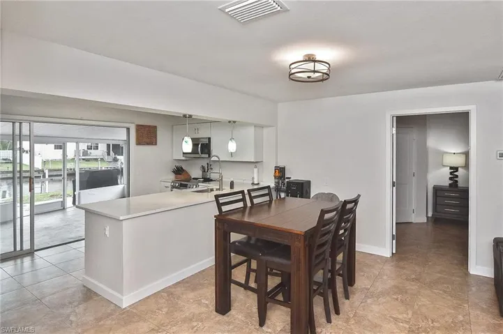 Dining area featuring visible vents and baseboards