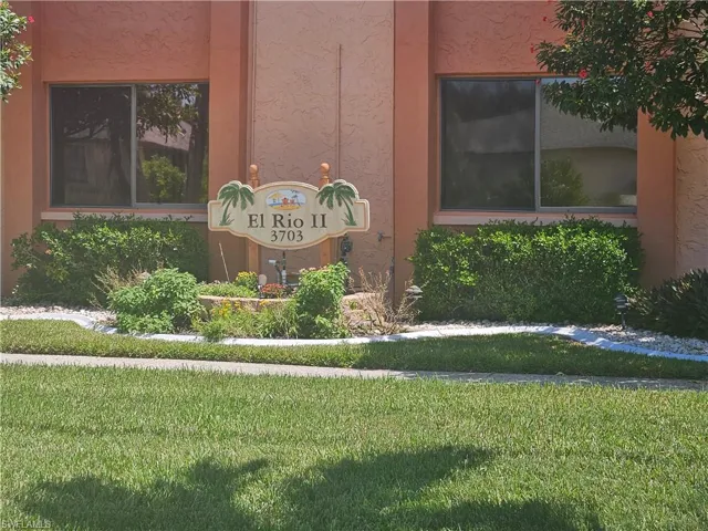 Community / neighborhood sign with a yard