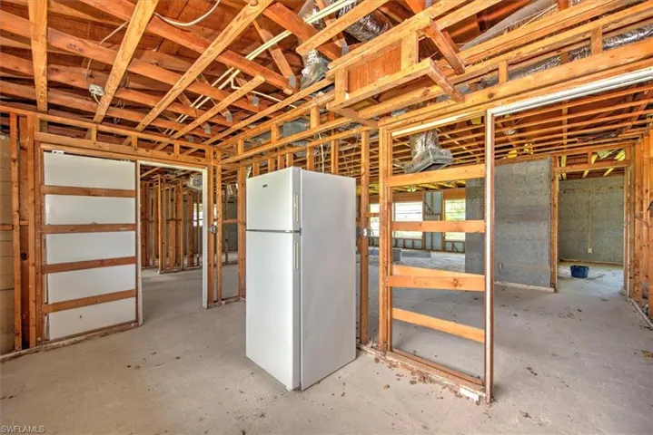Basement featuring white fridge