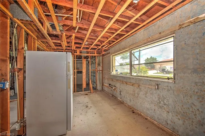 Basement with white fridge