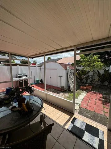 View of patio with a storage shed