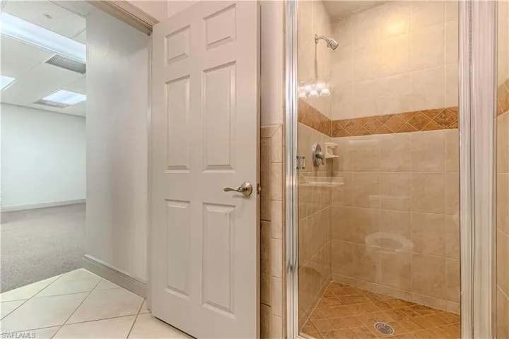 Bathroom with tile patterned flooring and walk in shower