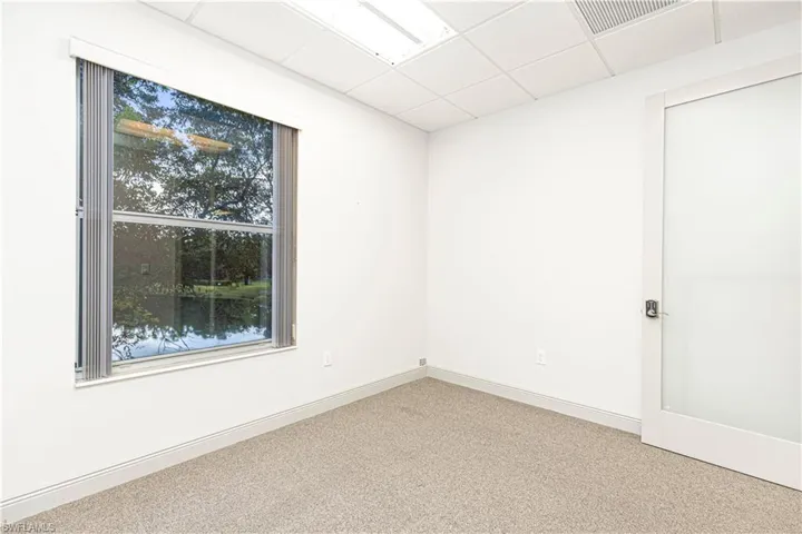 Unfurnished room featuring a paneled ceiling and carpet floors