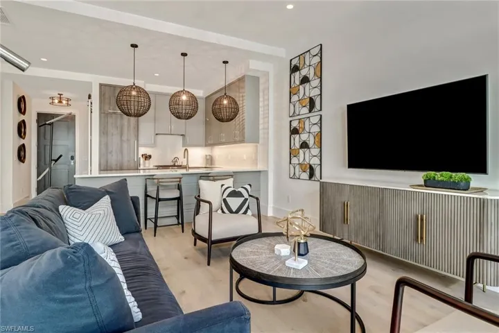 Living area with light wood-style flooring and baseboards