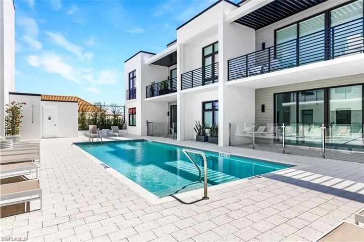 Community pool with a patio and a balcony