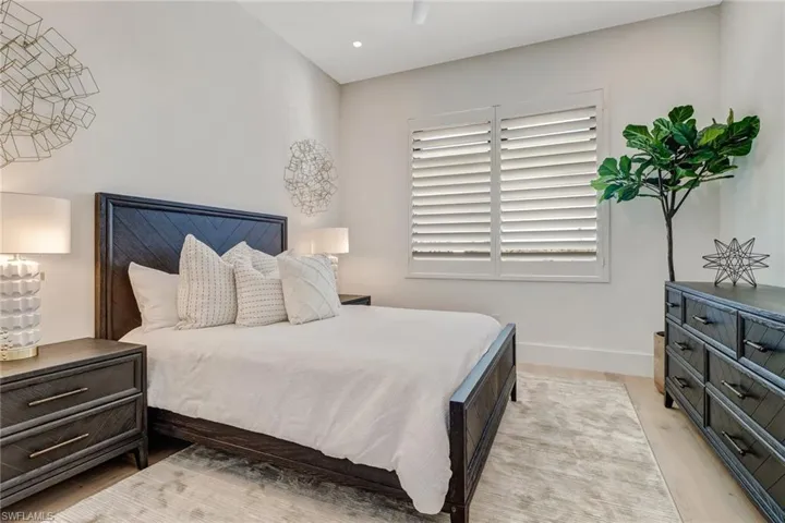 Bedroom featuring light wood-type flooring and a ceiling fan