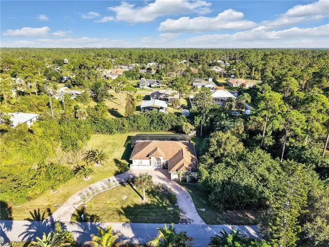 Aerial view of residential area featuring a heavily wooded area