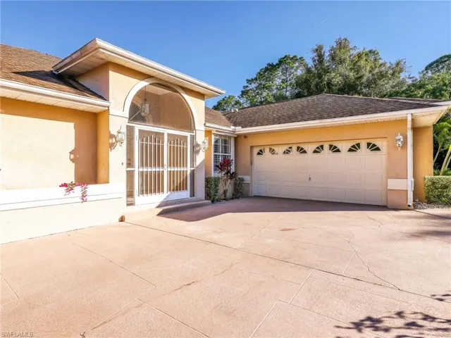 View of front of property featuring concrete driveway, stucco siding, an attached garage, and roof with shingles