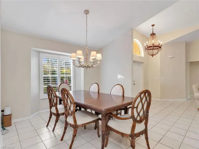 Dining space featuring a chandelier and light tile patterned floors