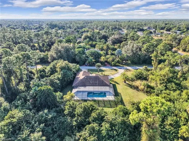 Aerial view of property's location with a forest