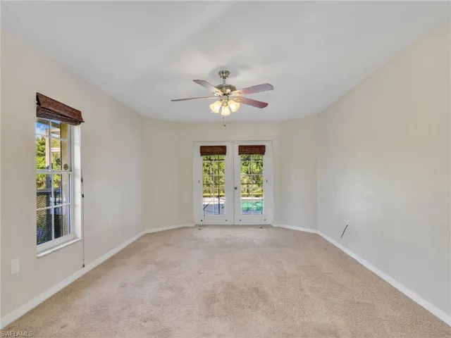 Primary bedroom featuring carpet and a ceiling fan