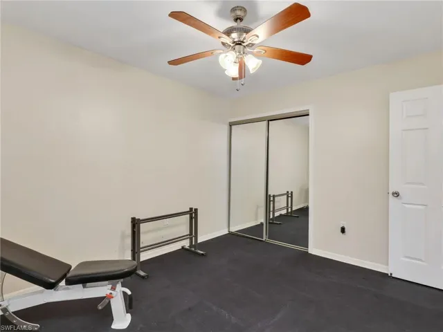 Exercise room with baseboards and a ceiling fan