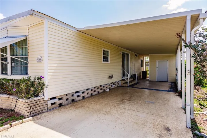 View of side of home with a carport