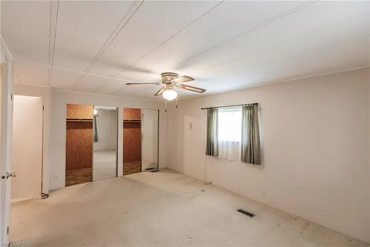 Unfurnished bedroom with carpet flooring and ceiling fan
