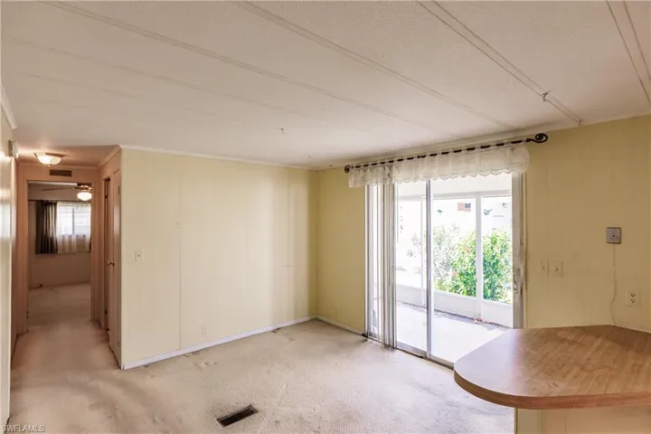 Spare room featuring carpet flooring, ornamental molding, and a textured ceiling