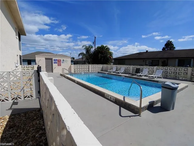 Rectangular inground pool with concrete decking and metal handrails