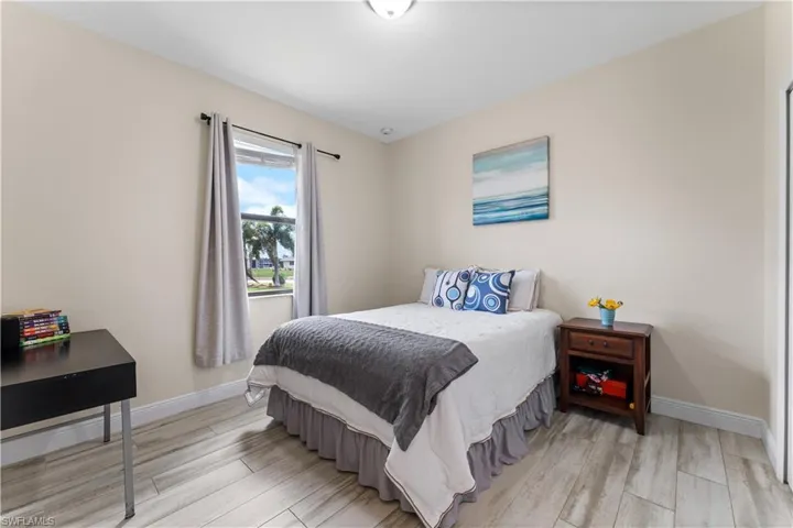 Bedroom with baseboards and light wood-type flooring