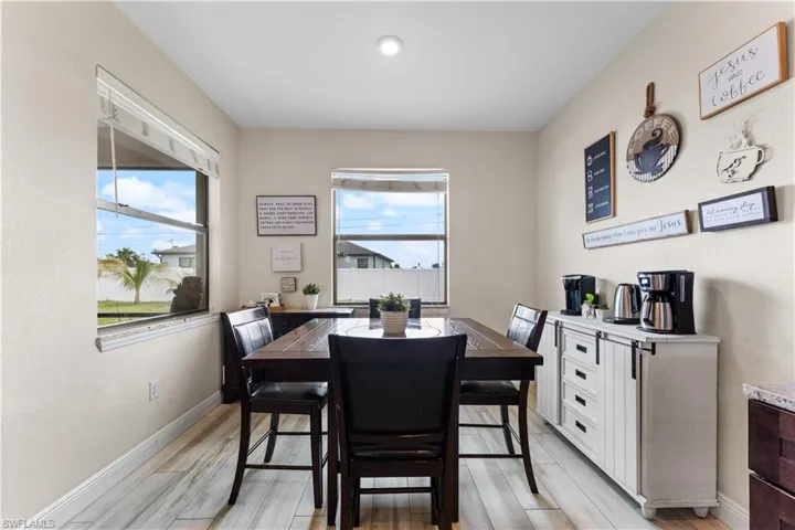 Dining space featuring light wood finished floors, baseboards, and a healthy amount of sunlight