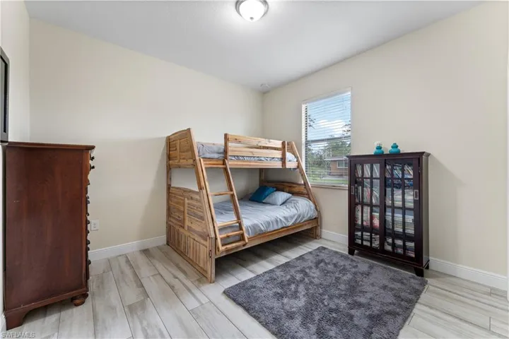 Bedroom featuring baseboards and wood finished floors