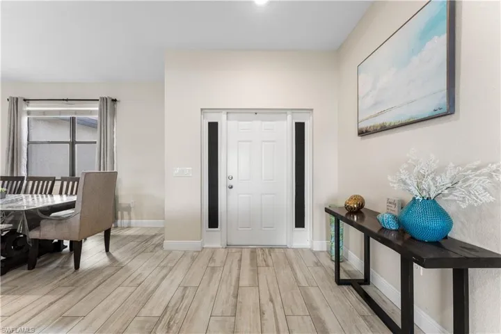 Foyer featuring light wood-style floors and baseboards