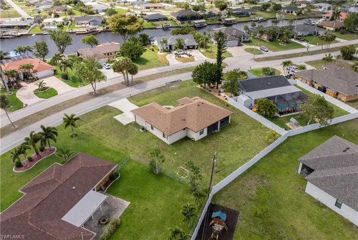 Birds eye view of property featuring a residential view and a water view