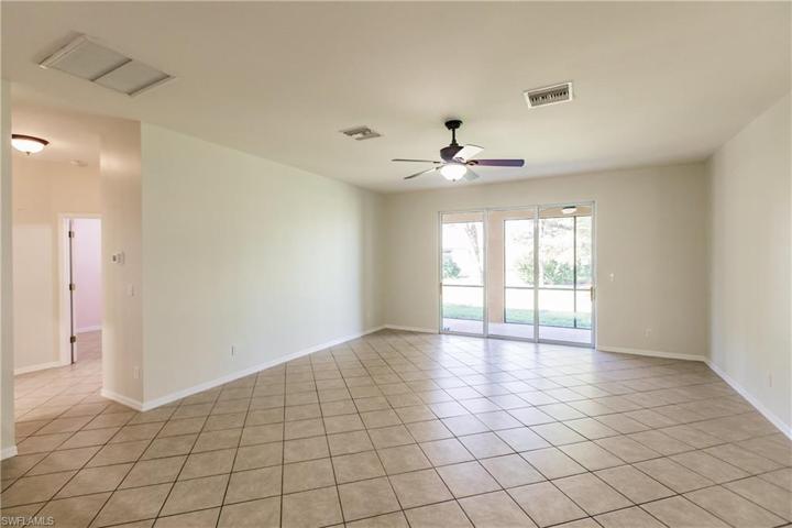 ENORMOUS "GREAT ROOM" WITH 3 SLIDING GLASS DOORS TO THE LANAI & THAT LARGE WALL IS DEFINITELY READY FOR THAT 85" T.V.