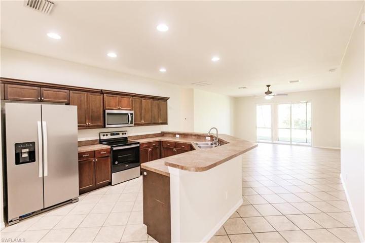 HUGE KITCHEN WITH THE "GREAT ROOM" IN THE BACKGROUND! ALL TILE! NO CARPET!