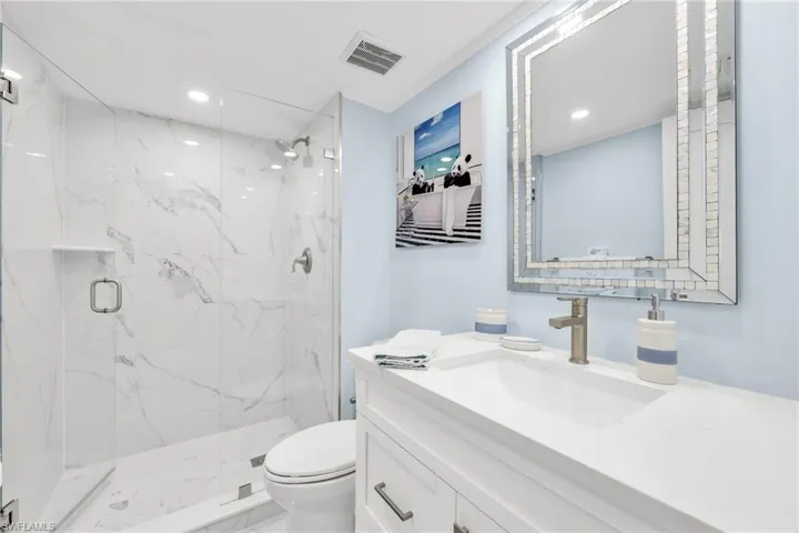 Full bathroom with a marble finish shower, vanity, recessed lighting, and marble finish flooring