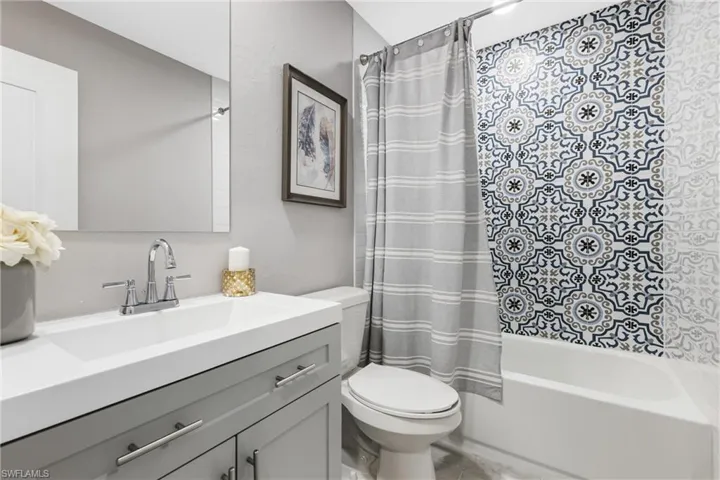 The New Guest Bath has a Shaker Vanity, Designer Tiled Shower, New Tub, New Toilet, New Mirror, etc.