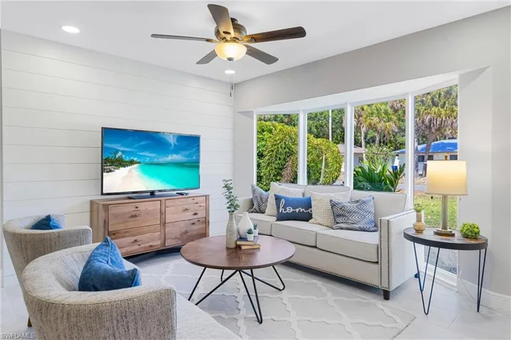 This is the Living Room with Custom Shiplap Focal Wall & oversized Windows