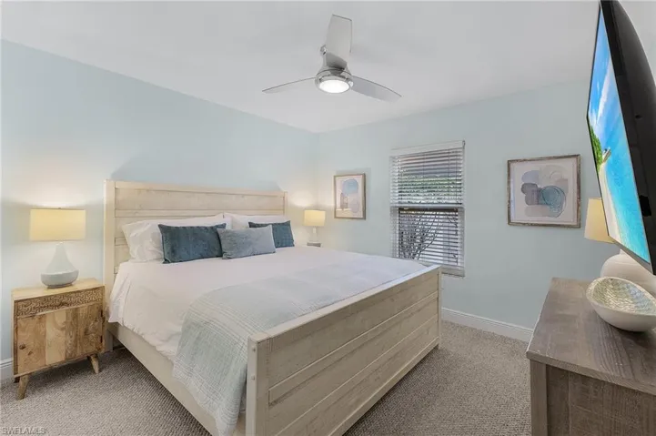 Bedroom featuring ceiling fan and light colored carpet